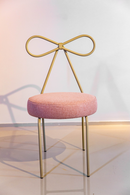 Cadeira Lace em aço carbono, com encosto em formato de laço, assento estofado em tecido nas cores rosa e taupe. Design elegante e confortável, ideal para salas de jantar e home office. Acompanha uma unidade.