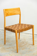 Cadeira de jantar com estrutura em madeira nobre e assento trançado em couro legítimo. Design sofisticado e ergonômico, ideal para salas de jantar refinadas. Acompanha uma unidade.