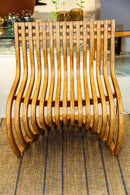 Poltrona Pantosh com design geométrico e escultural, inspirada na Cadeira Panton de Verner Panton e na Poltrona Willow de Charles Rennie Mackintosh. Estrutura em madeira maciça de alta qualidade, compensado multilaminado e acabamentos premium. Dimensões: 78 cm (A) x 66 cm (L) x 60 cm (P). Outros itens na fotografia não estão incluídos.